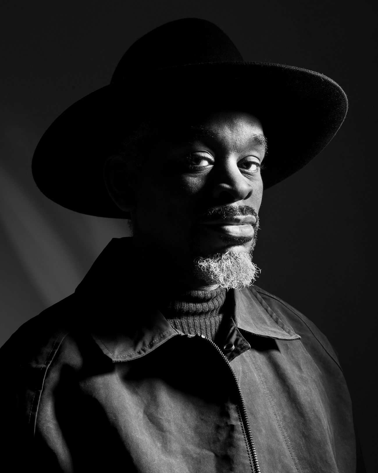 Black and white portrait of a man in a wide-brimmed hat